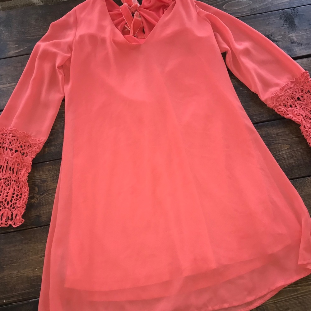 Coral dress with lace sleeves and bow back